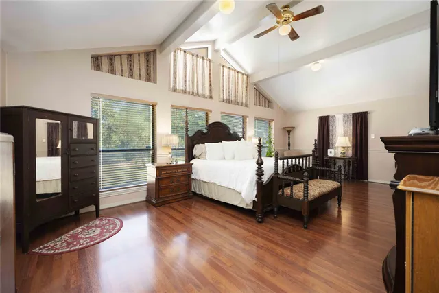 a bedroom with furniture and wooden floor
