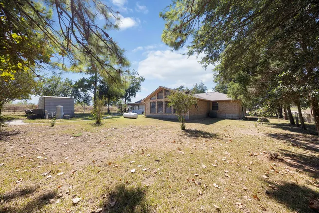 a view of a house with snow on the road