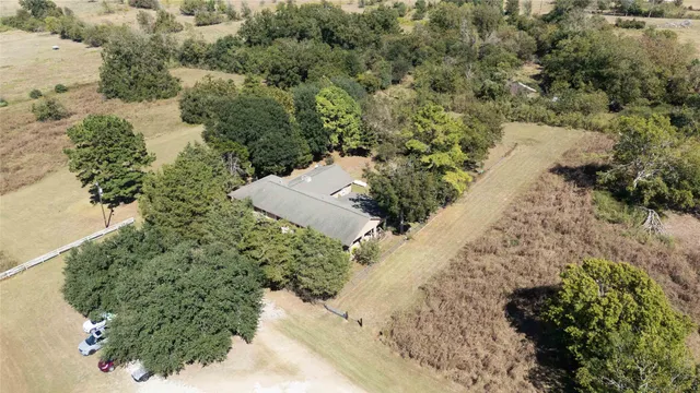 an aerial view of a house with a yard