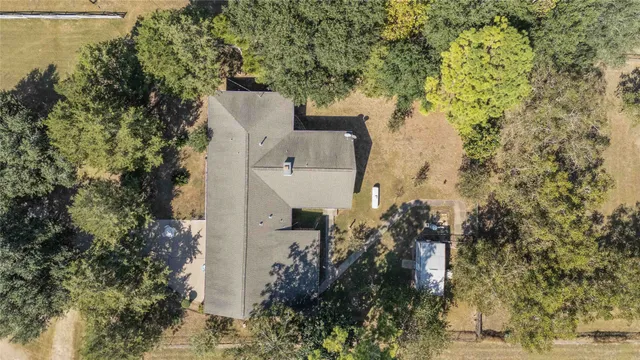 an aerial view of a house with yard and outdoor seating