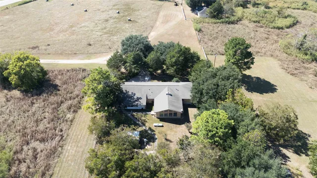 an aerial view of a house with a yard