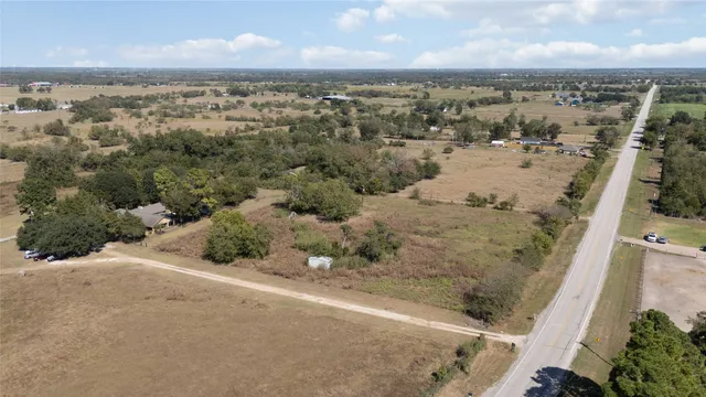 an aerial view of a houses with a ocean view