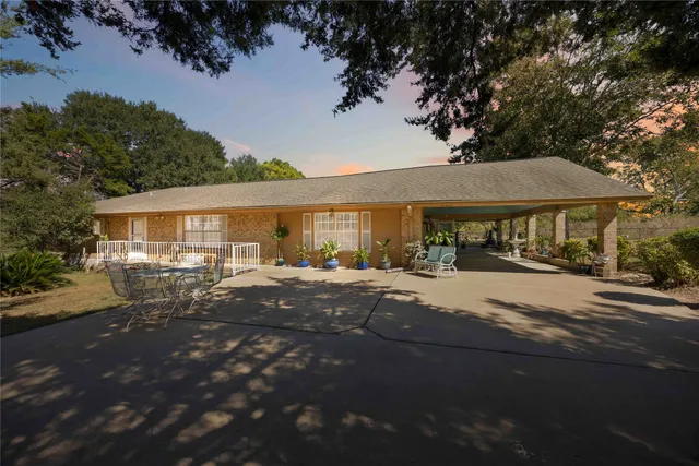 a front view of a house with yard patio and outdoor seating