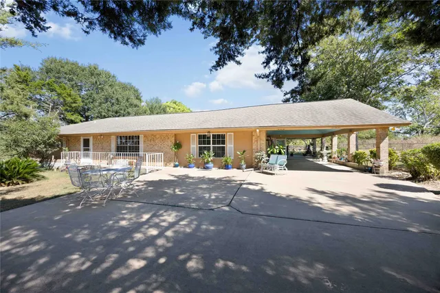 a patio with a table and chairs under an umbrella
