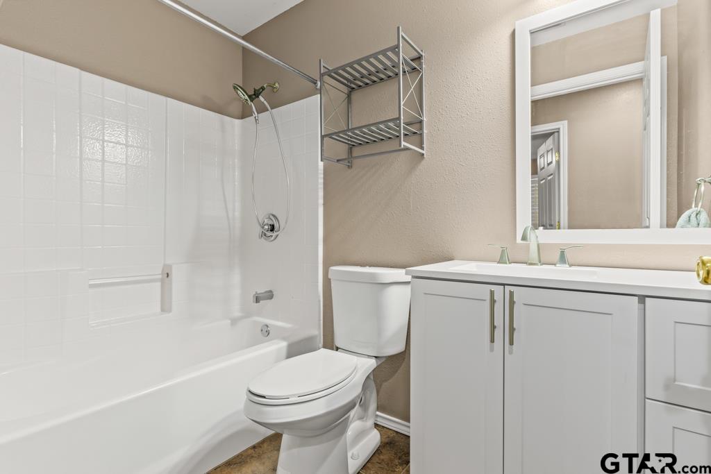 228 Cambridge Lane Longview, TX 75601 - Photo 12 of 26 a bathroom with a sink a toilet and shower