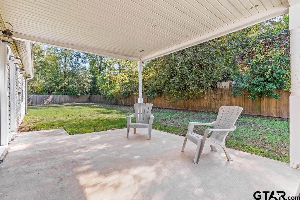 228 Cambridge Lane Longview, TX 75601 - Photo 19 of 26 a view of a chair and table in backyard of the house