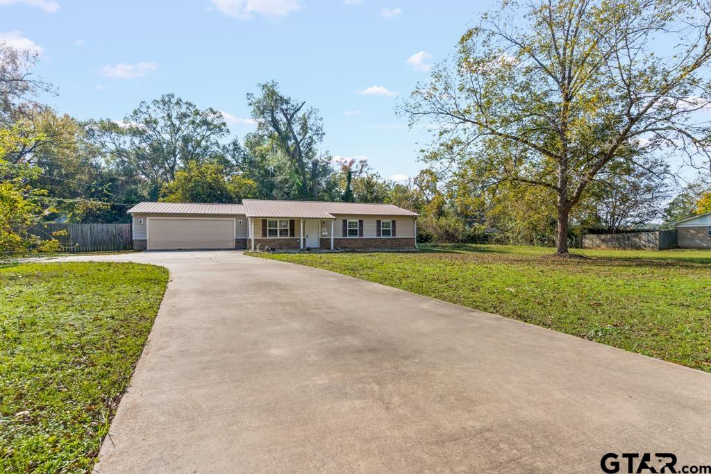 228 Cambridge Lane Longview, TX 75601 - Photo 23 of 26 a house view with a garden space