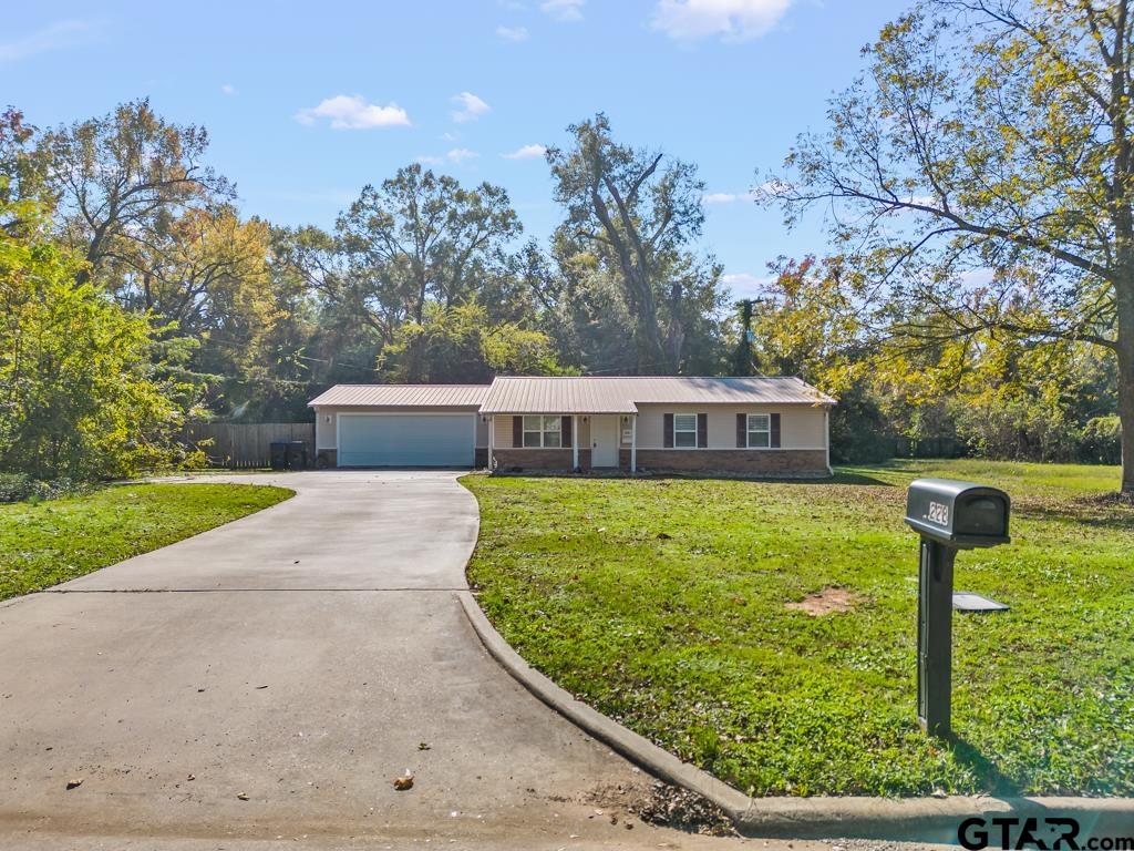 228 Cambridge Lane Longview, TX 75601 - Photo 3 of 26 a view of a swimming pool with a garden