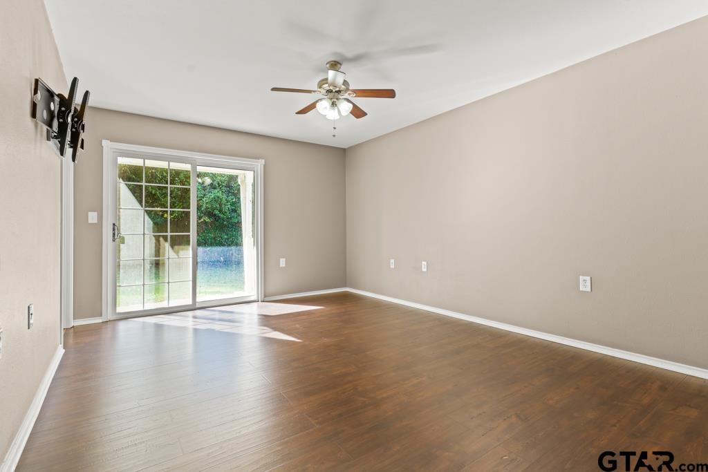 228 Cambridge Lane Longview, TX 75601 - Photo 5 of 26 an empty room with wooden floor and windows