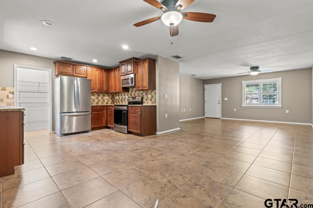 228 Cambridge Lane Longview, TX 75601 - Photo 8 of 26 a view of a kitchen with a sink and stainless steel appliances