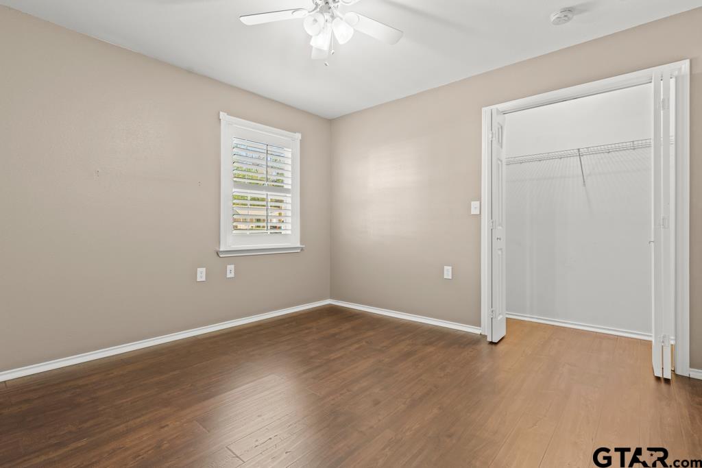 228 Cambridge Lane Longview, TX 75601 - Photo 10 of 26 an empty room with wooden floor and windows