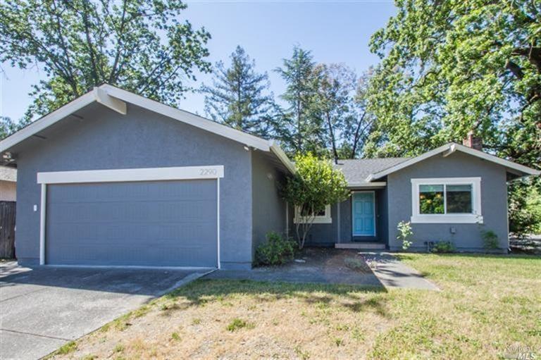 2290 Nightingale Drive Santa Rosa, CA 95403 - Photo 1 of 1 a front view of house with yard and trees in the background