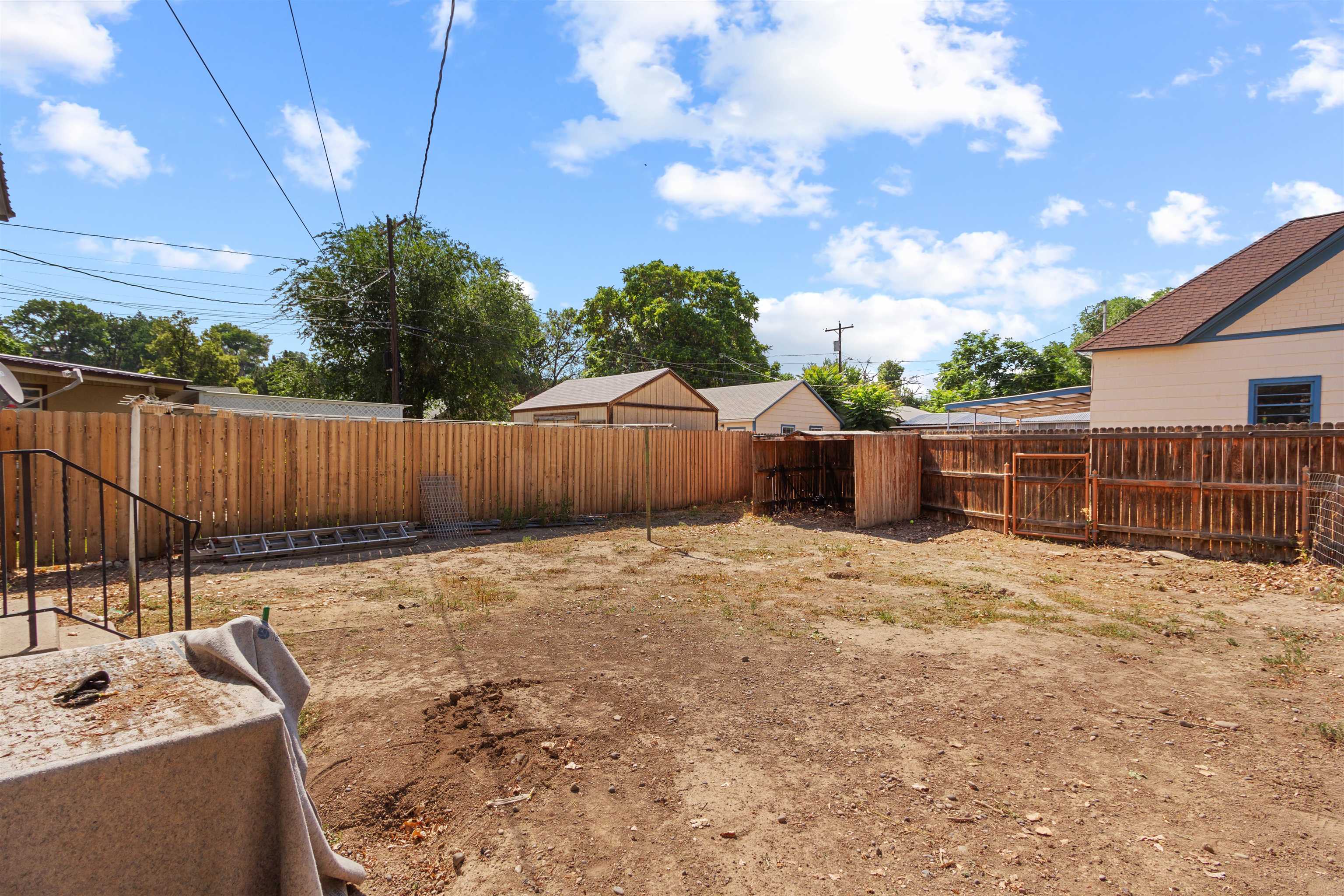 308 4th Street Delta, CO 81416 - Photo 19 of 21 a backyard of a house with table and chairs