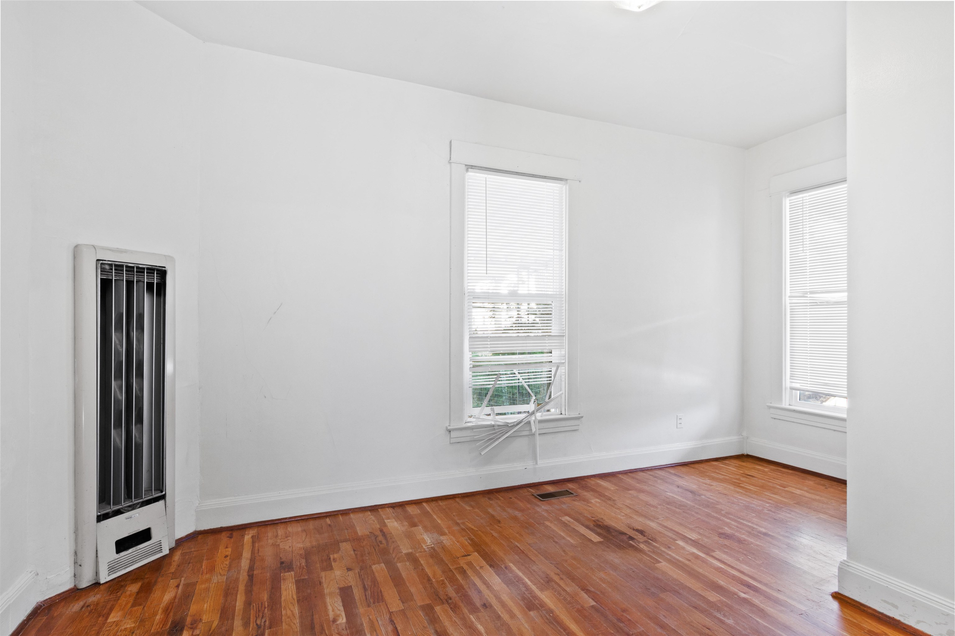 308 4th Street Delta, CO 81416 - Photo 8 of 21 an empty room with wooden floor and windows