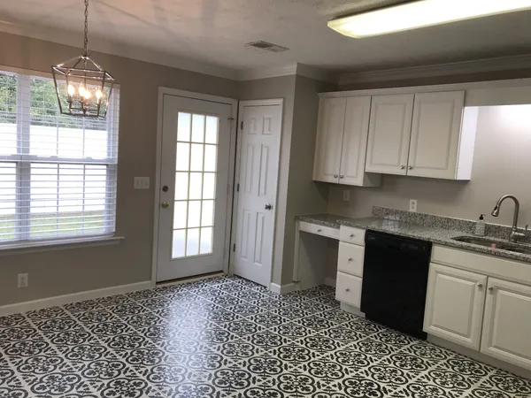 a kitchen with a sink a stove and cabinets