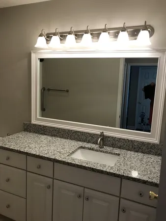 a sink with a sink and mirror