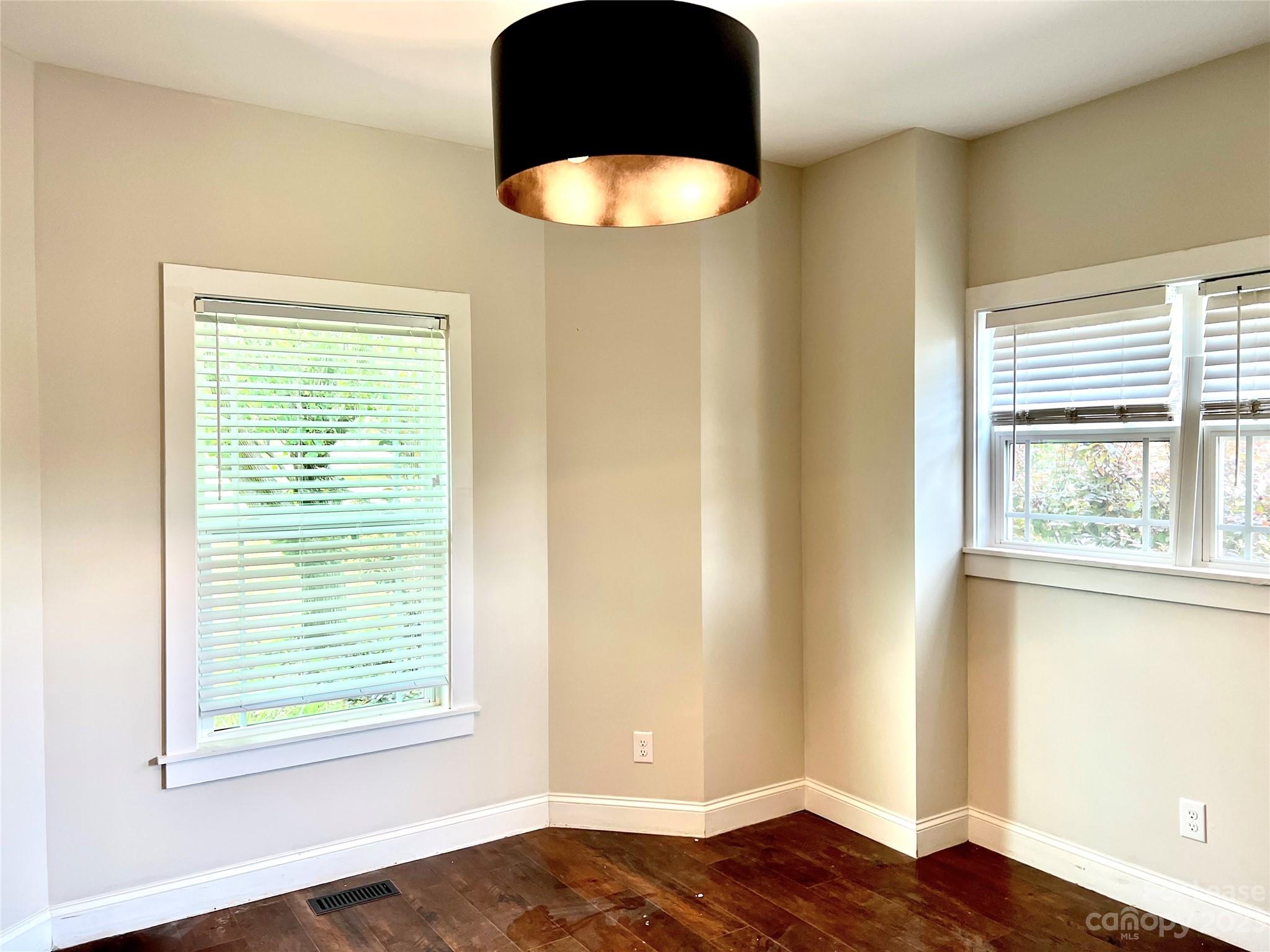 7640 Campground Road Denver, NC 28037 - Photo 3 of 9 a view of an empty room with wooden floor and a window