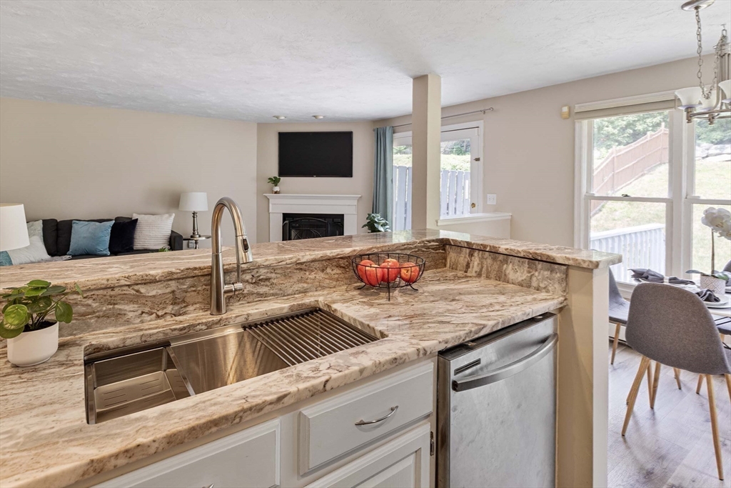 21 Midgley Lane Worcester, MA 01604 - Photo 12 of 25 a kitchen with stainless steel appliances granite countertop a sink and a stove
