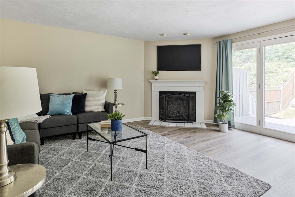 21 Midgley Lane Worcester, MA 01604 - Photo 16 of 25 a living room with furniture a flat screen tv and a fireplace