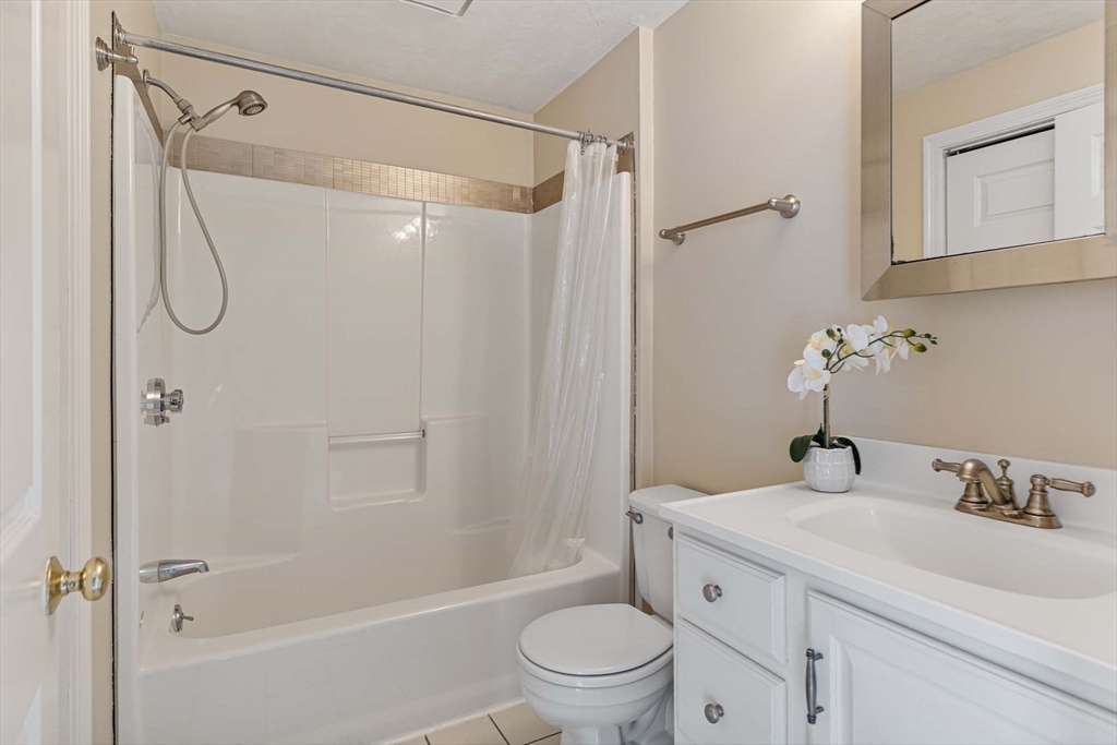 21 Midgley Lane Worcester, MA 01604 - Photo 21 of 25 a bathroom with a granite countertop sink a toilet and shower