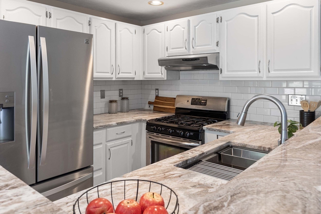 21 Midgley Lane Worcester, MA 01604 - Photo 9 of 25 a kitchen with stainless steel appliances granite countertop a stove a refrigerator and a sink