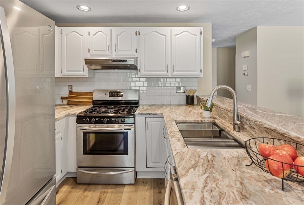 21 Midgley Lane Worcester, MA 01604 - Photo 10 of 25 a kitchen with granite countertop a stove and a sink