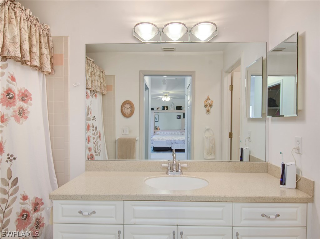 18205 Apple Road Fort Myers, FL 33967 - Photo 13 of 25 a bathroom with a sink and a mirror