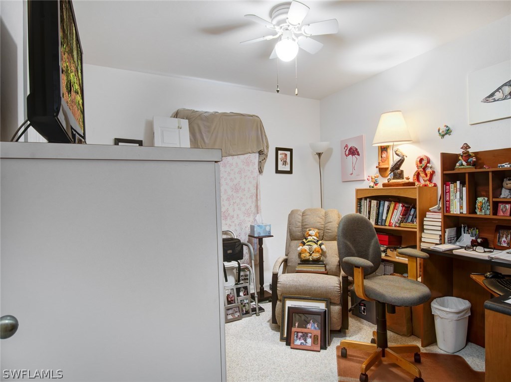 18205 Apple Road Fort Myers, FL 33967 - Photo 18 of 25 a work room with furniture and a book shelf