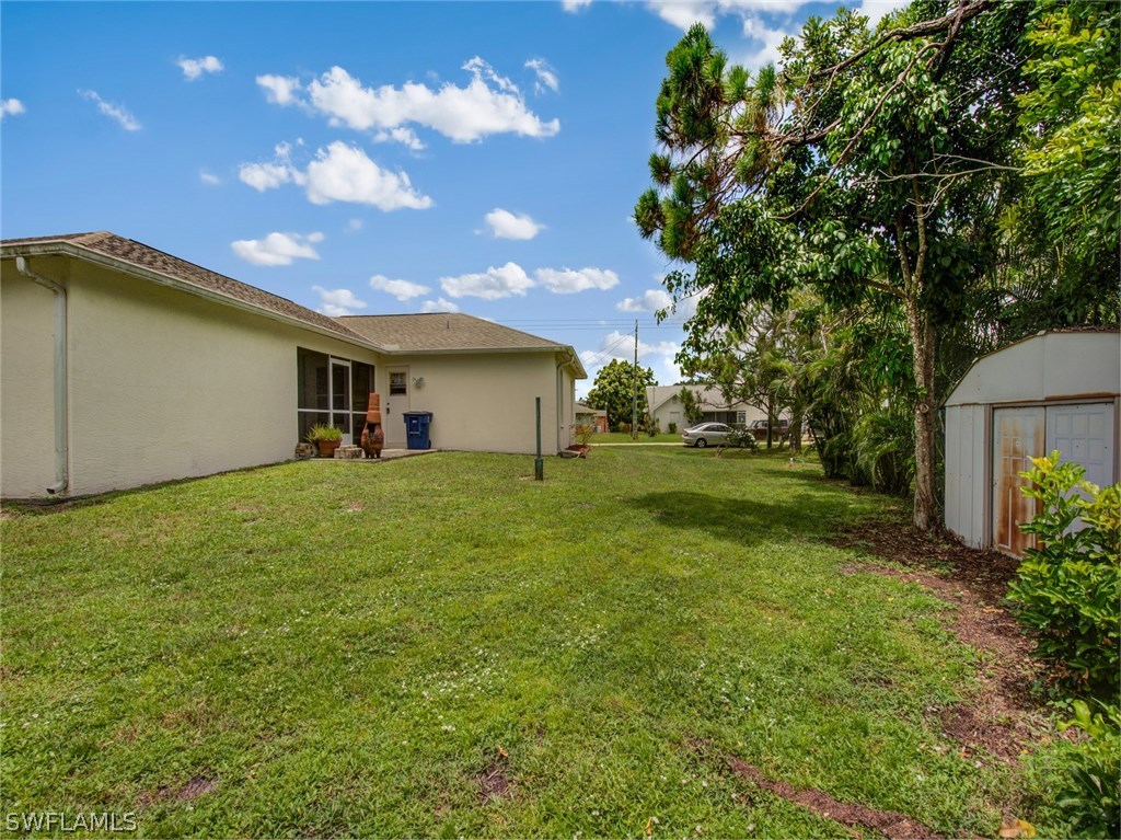 18205 Apple Road Fort Myers, FL 33967 - Photo 22 of 25 a front view of a house with garden