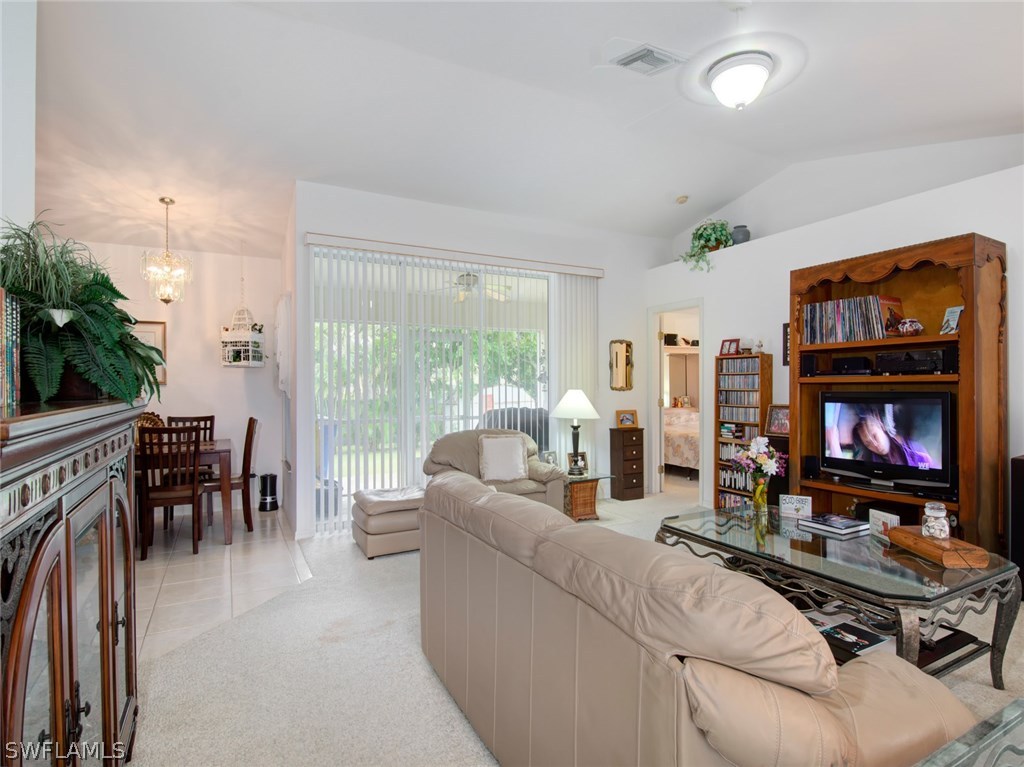 18205 Apple Road Fort Myers, FL 33967 - Photo 4 of 25 a living room with furniture fireplace and a large window