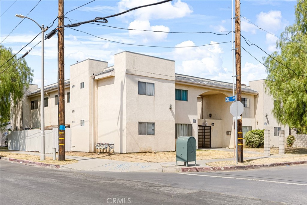 a view of a street with a building on the roadside