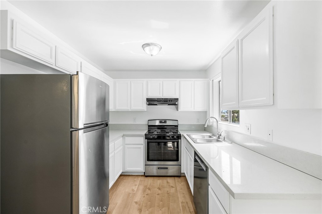 11151 Arminta Street, Unit 201A Sun Valley, CA 91352 - Photo 3 of 14 a kitchen with a sink a stove and refrigerator