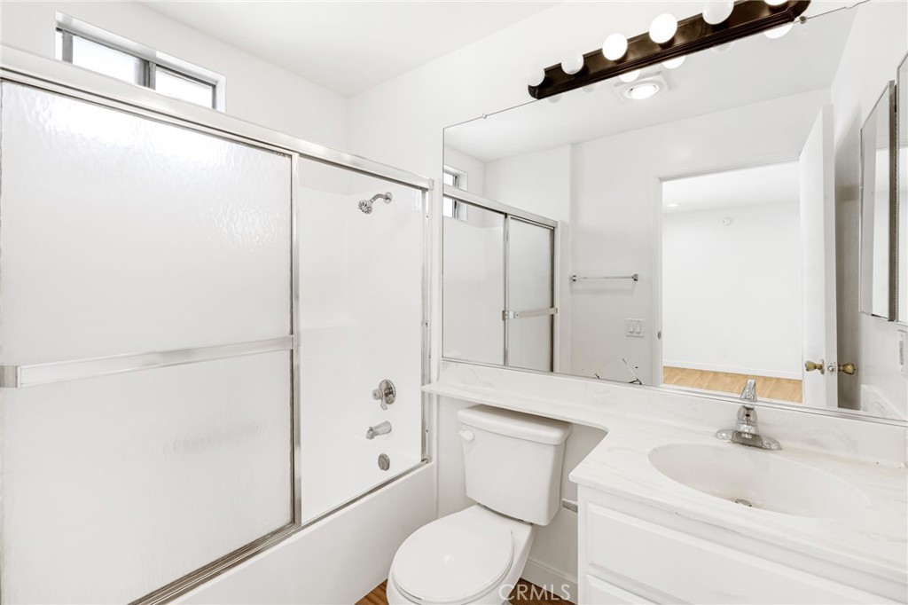 11151 Arminta Street, Unit 201A Sun Valley, CA 91352 - Photo 7 of 14 a bathroom with a sink a toilet a mirror and shower
