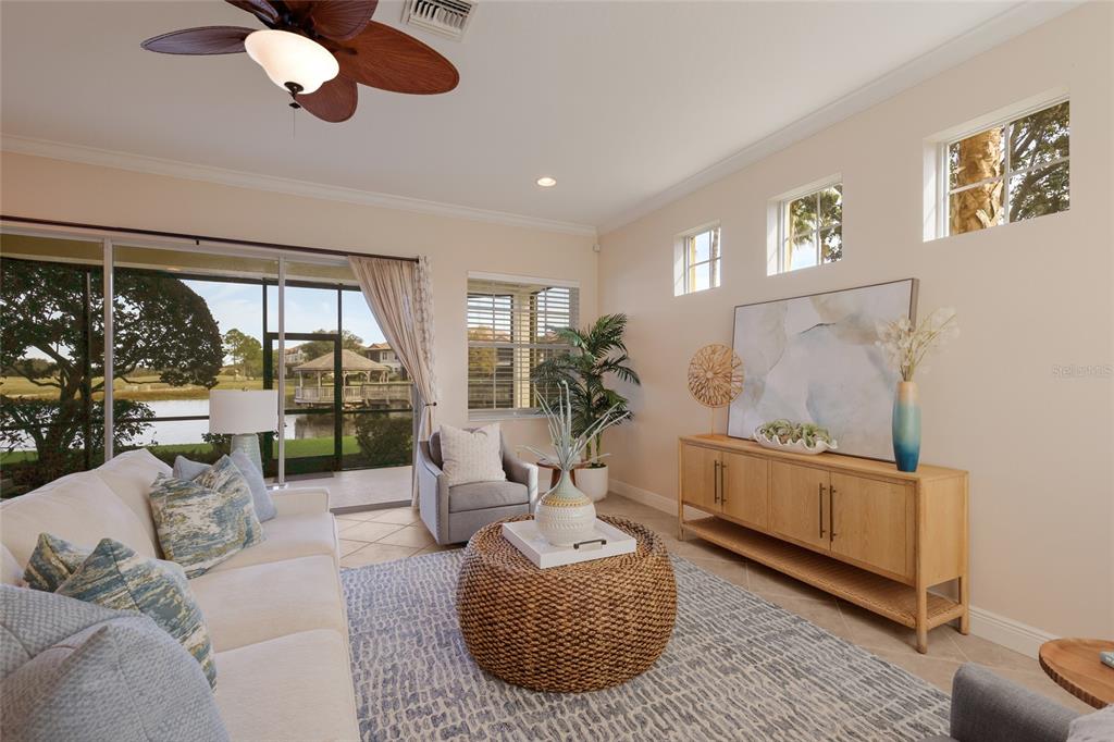 8336 Miramar Way Lakewood Ranch, FL 34202 - Photo 11 of 63 a living room with furniture chandelier and a large window