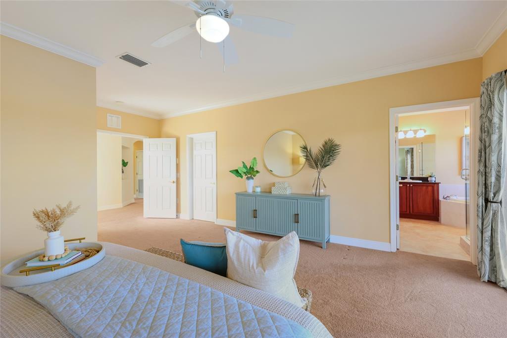 8336 Miramar Way Lakewood Ranch, FL 34202 - Photo 23 of 63 a bedroom with a bed and chandelier