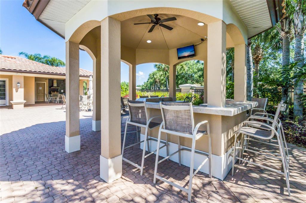 8336 Miramar Way Lakewood Ranch, FL 34202 - Photo 53 of 63 a view of a patio with a dining table and chairs