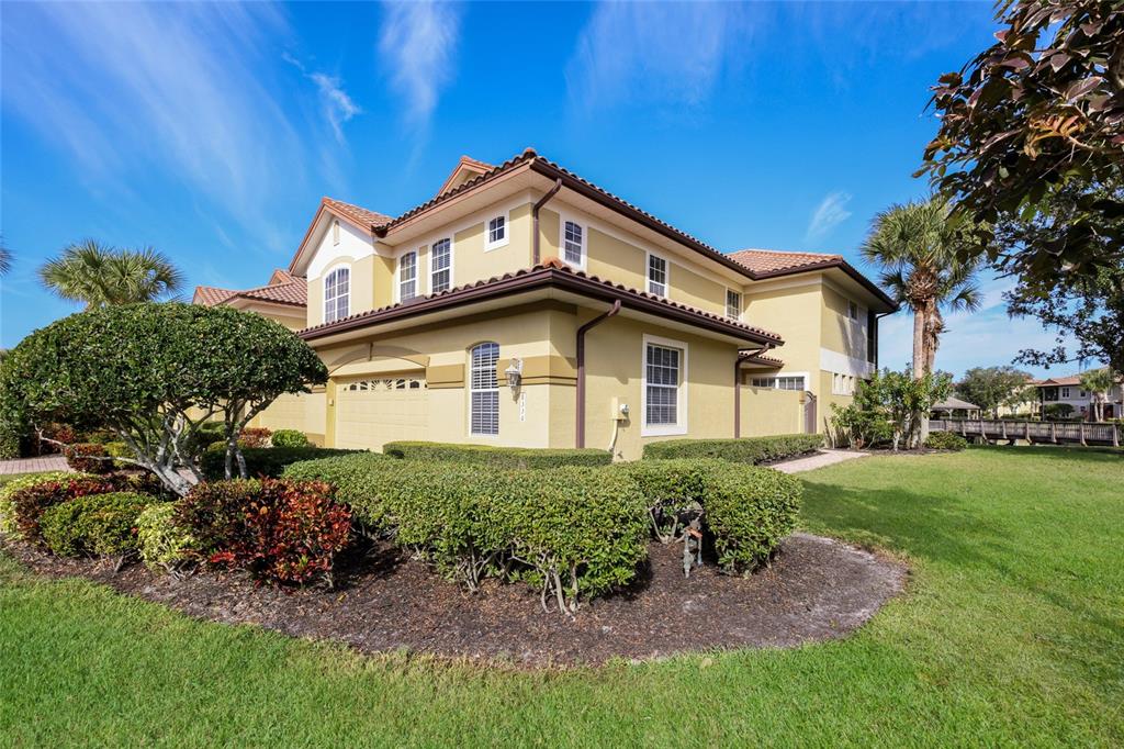 8336 Miramar Way Lakewood Ranch, FL 34202 - Photo 6 of 63 a view of a house with a small yard and plants