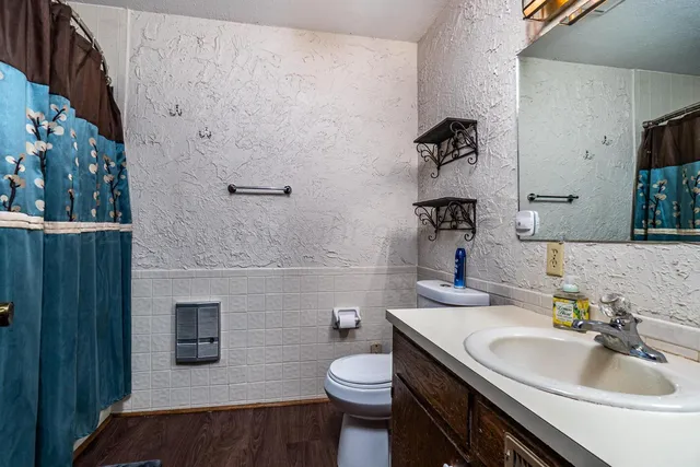 a bathroom with a sink toilet and shower