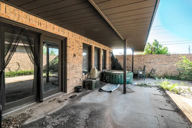 a view of a porch with furniture and garden