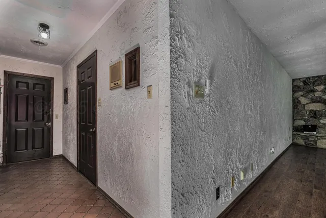 a view of a hallway with wooden shelves