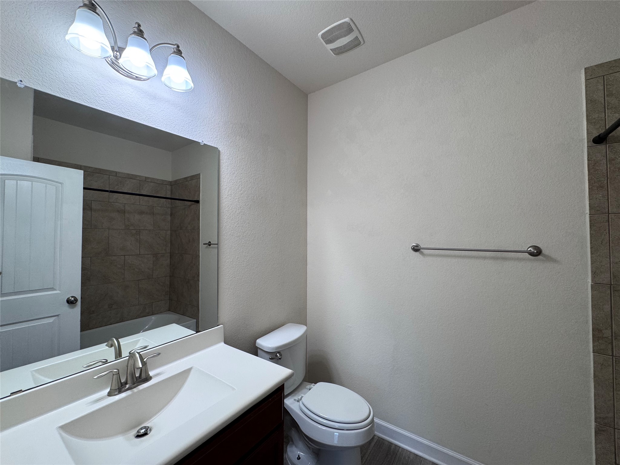 2605 Rough Berry Road Pflugerville, TX 78660 - Photo 26 of 40 A well-appointed bathroom offers modern fixtures and a tiled shower-tub combination.