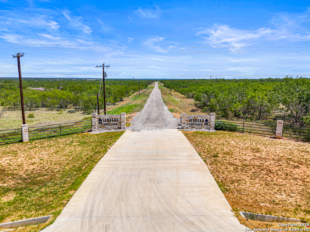 0 Pr Riley Poteet, TX 78065 - Photo 2 of 11 a view of swimming pool with lawn chairs under an umbrella