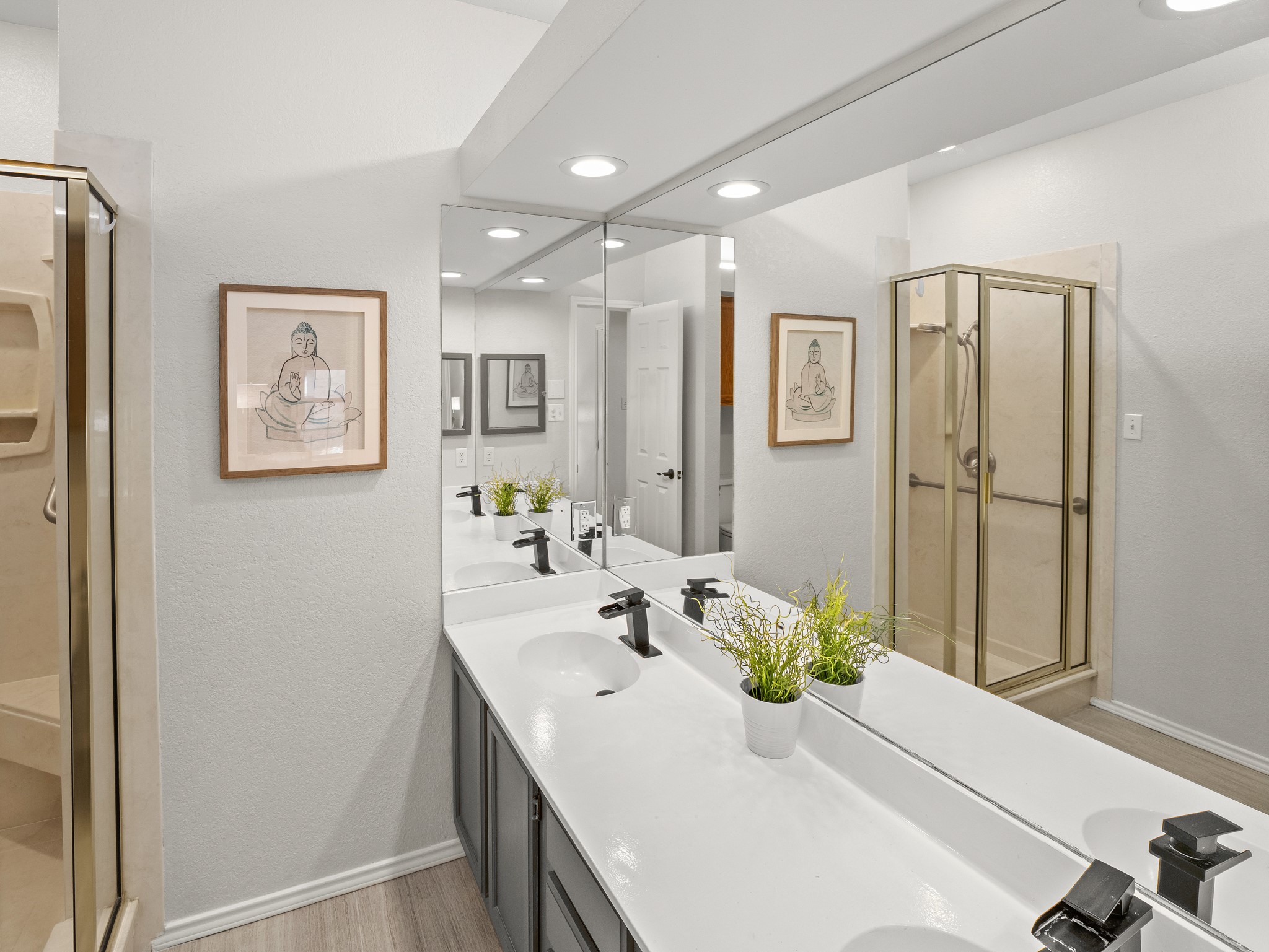 3809 Spicewood Springs Road, Unit 137 Austin, TX 78759 - Photo 12 of 34 Double vanities and modern fixtures define this bathroom, offering ample space and clean lines.