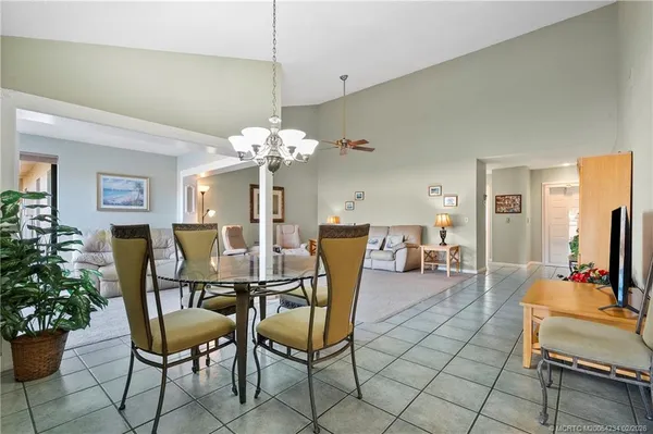 a dining room with furniture a livingroom and chandelier