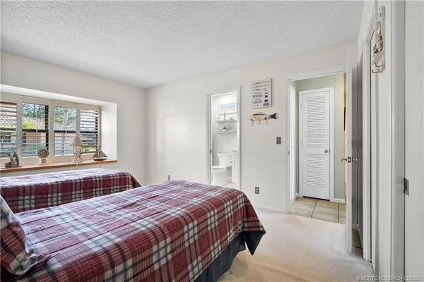 a bedroom with a large bed and a large window