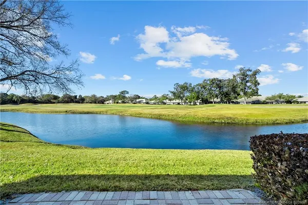 a view of a lake with houses in the back