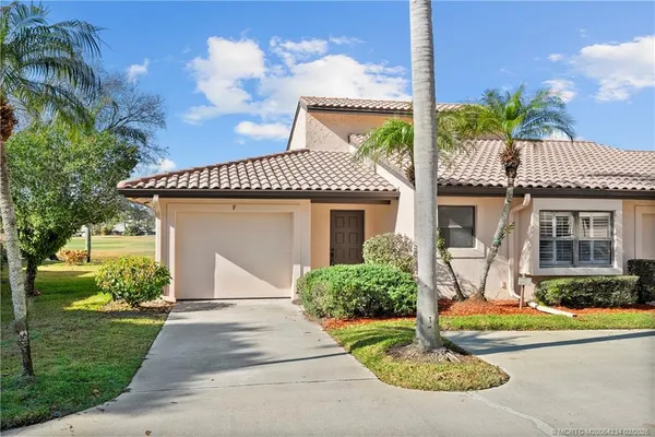 a front view of a house with a porch and furniture