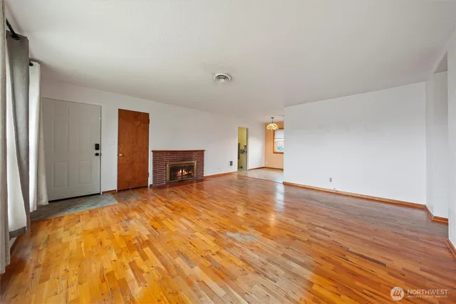 an empty room with windows and wooden door