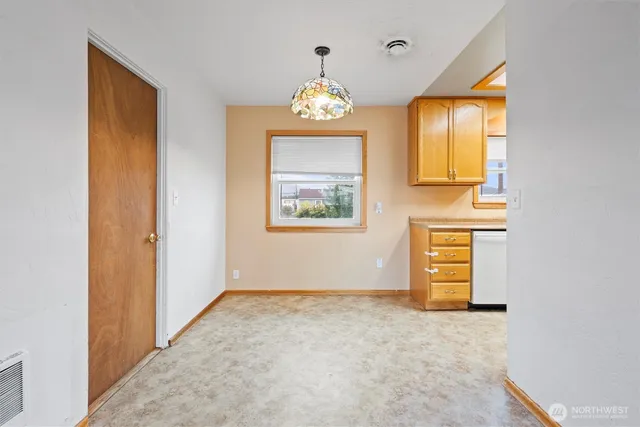 a kitchen with stainless steel appliances granite countertop a sink and dishwasher with wooden floor