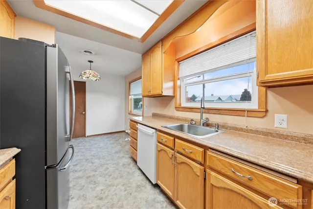 a view of livingroom with kitchen furniture and windows
